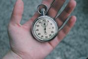 Close Up of Hand Holding Stopwatch Outdoors