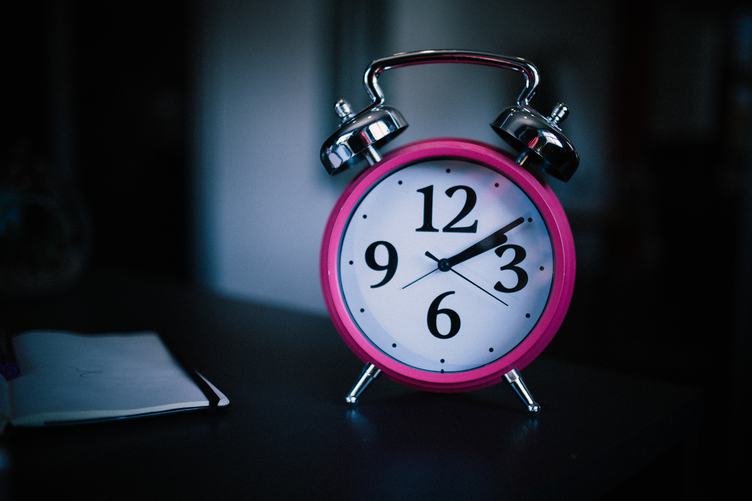 Pink Alarm Clock on Dark Background