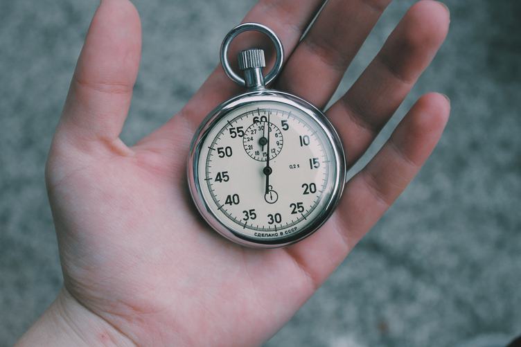 Close Up of Hand Holding Stopwatch Outdoors