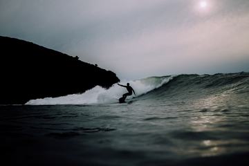 Silhouette Man Surfing Wave