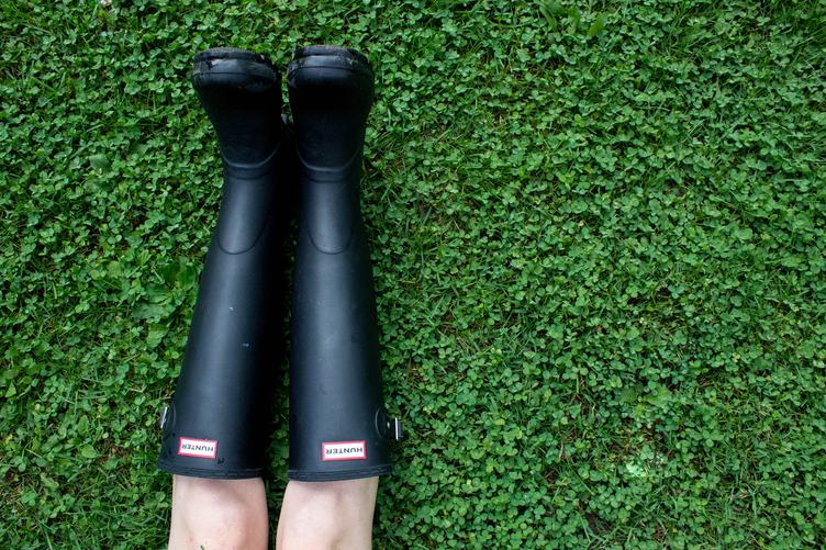 Person Wearing Wellington Boots Lying on Grass