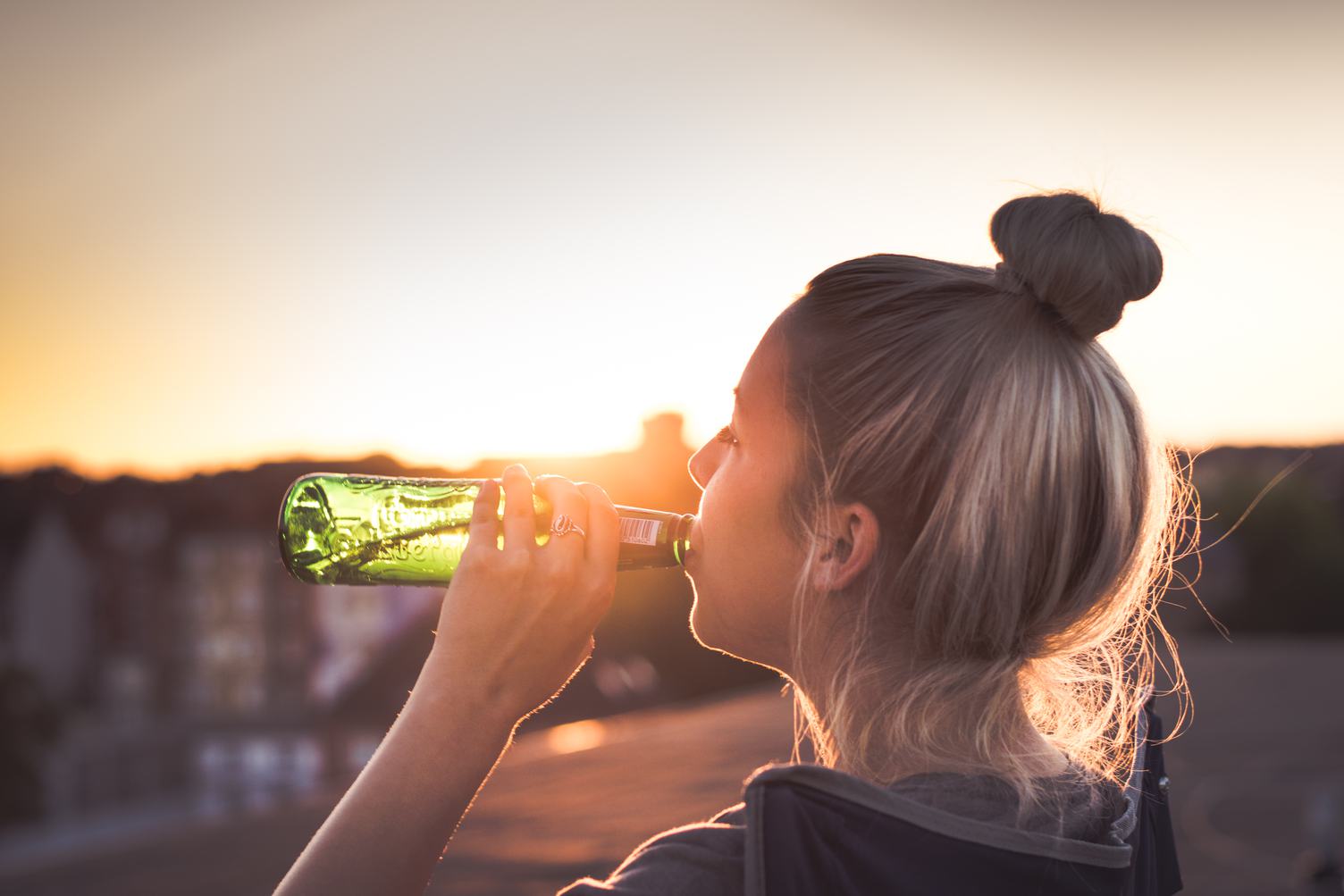 Girl Drinking a Beer at the Sunset