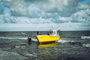 Yellow Fishing Boat Returns to the Shore