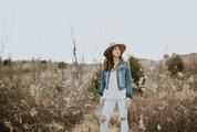 Brunette Woman Standing on a Meadow