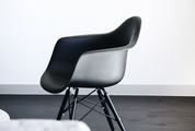 Modern Black Chair in White Room Interior with a Dark Floor