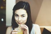 Young Brunette Drinking Cold Juice