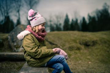 Child Girl in Warm Jacket and Hat