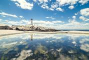 A Lighthouse Reflection with Calm Waters