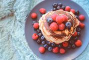 Pancakes with Blueberries and Raspberries on Black Plate