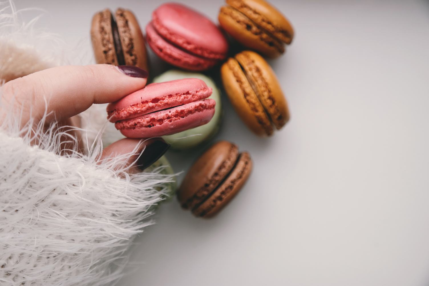 Woman Holding Colorful Delicious Macaroons