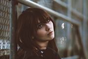 Young Woman Lean on Fence