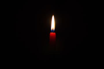 Red Candle against Black Background