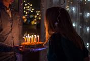 Birthday Man Holding a Cake with Candles for his Girlfriend
