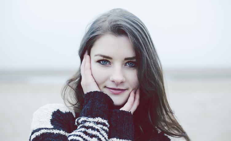 Beautiful Young Woman in a Black and White Knitted Sweater