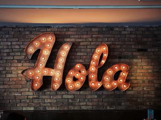 Electric Bulbs Retro Light Frame with Light Text of Hola