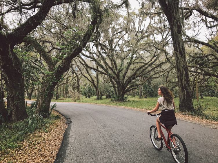 A Young Woman Is Cycling in the Park