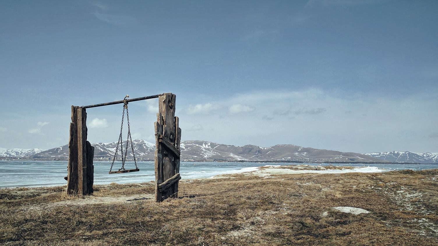 Empty Wooden Rural Swing in Scenic Mountain Landscape