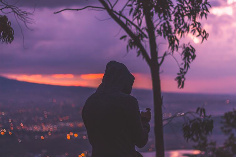 Sunset at the Mountain View with a Man Wearing Hood
