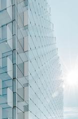 Glass Facade of Modern Office Building with Glare Reflection
