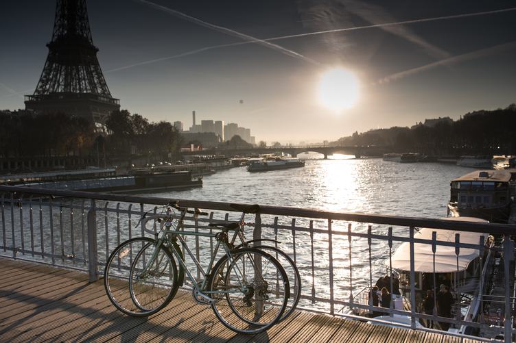 Two Bicycles Standing on the Bridge next to the Eiffel Tower in Paris, France