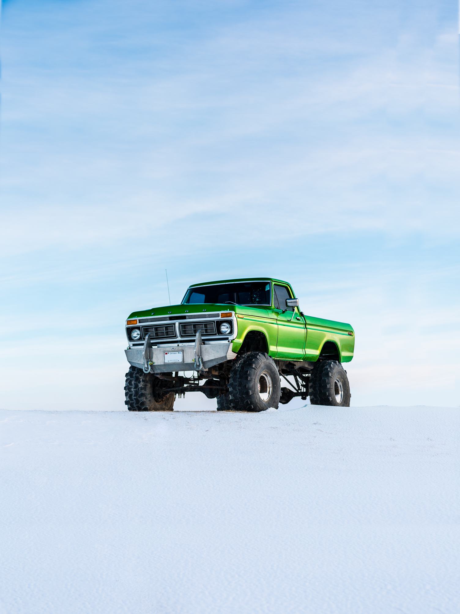 A Large Green Pickup Truck in the Snow