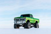 A Large Green Pickup Truck in the Snow