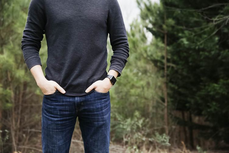 Man Standing in the Forest with Apple Watch on Hand