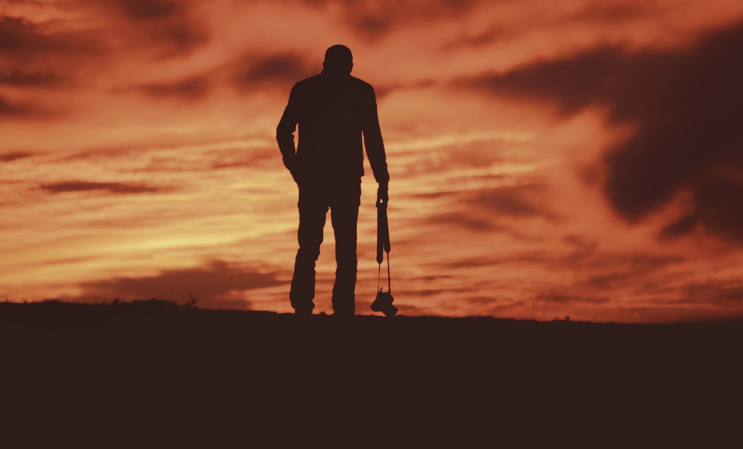 Photographer with Camera Silhouette on Sunset Sky Background
