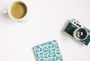 Flat Lay Photography with Camera, Coffee and Notebook on White Background