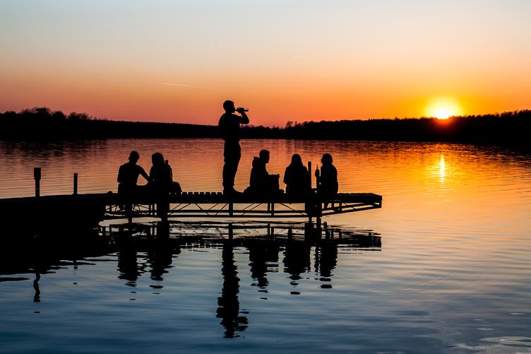 Free Photo: Silhouette of Group of Friends Sitting and Drinking on a Lake  Pier at Sunset