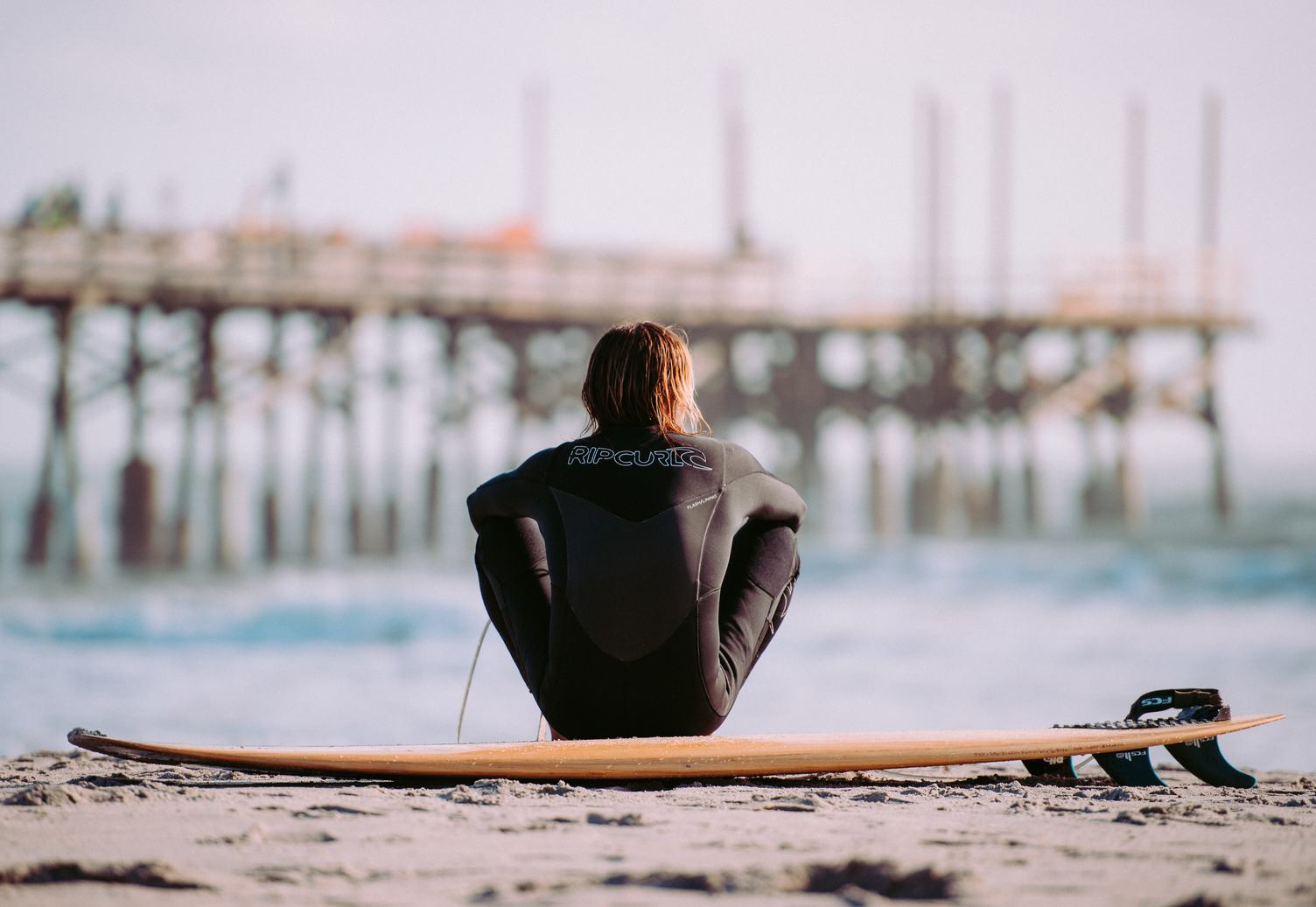 Surfer on the Beach with His Board