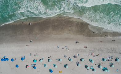 Aerial View of Sandy Beach with Tourists