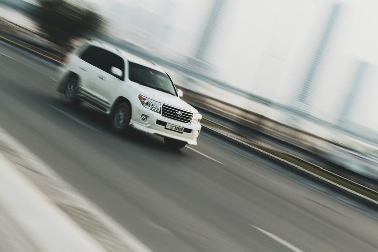 White Car Moving against Blurred Background