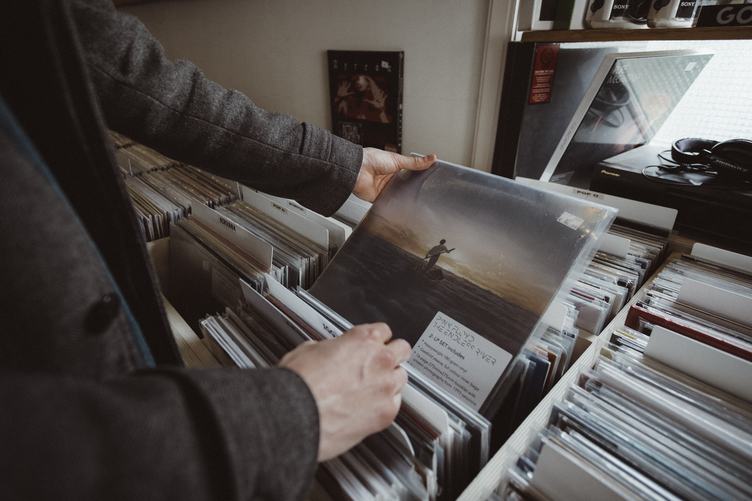 Man Browsing Through Records at a Vinyl Shop
