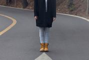 Young Girl Standing in the Middle of the Road