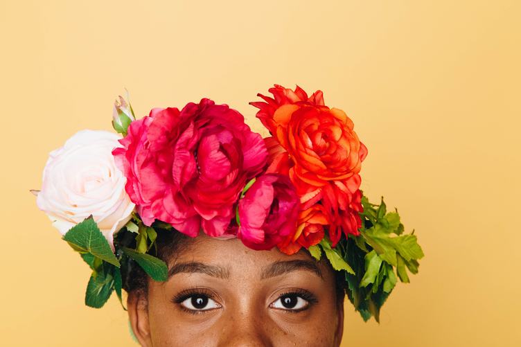 Woman with Flower Wreath on Her Head against Yellow Background