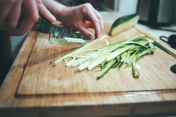 Cut Zucchini in Long Strips on Chopping Board for Cooking