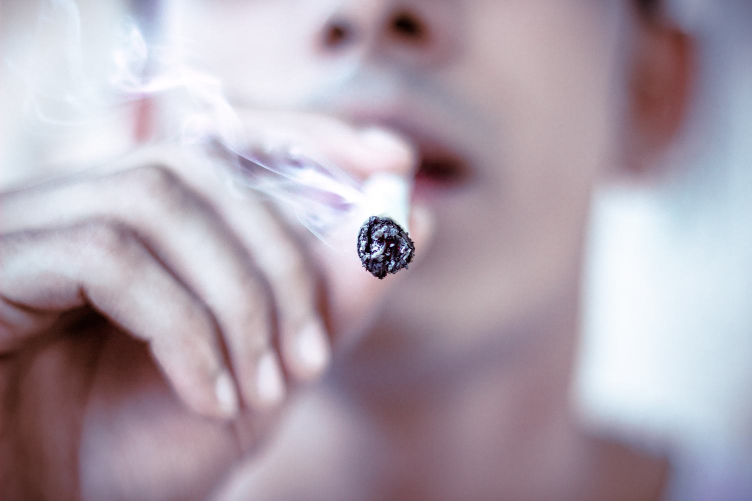 Young Man Smoking Cigarette, Closeup