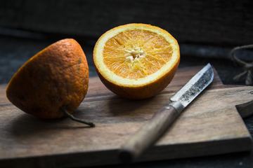 Halved Orange on Wooden Board