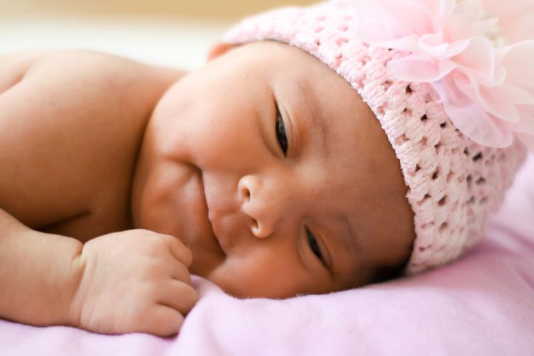 Little Baby Girl Lying on Pink Blanket