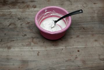 Pink Bowl of Cream on Old Wooden Table