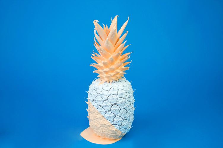 Pineapple Fruit Covered with Paint on Blue Background