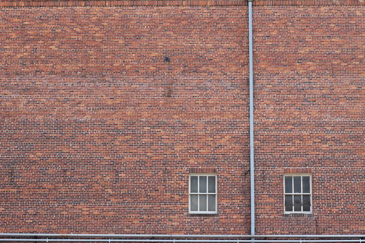 Old Wall Made of Red Brick with Two Windows