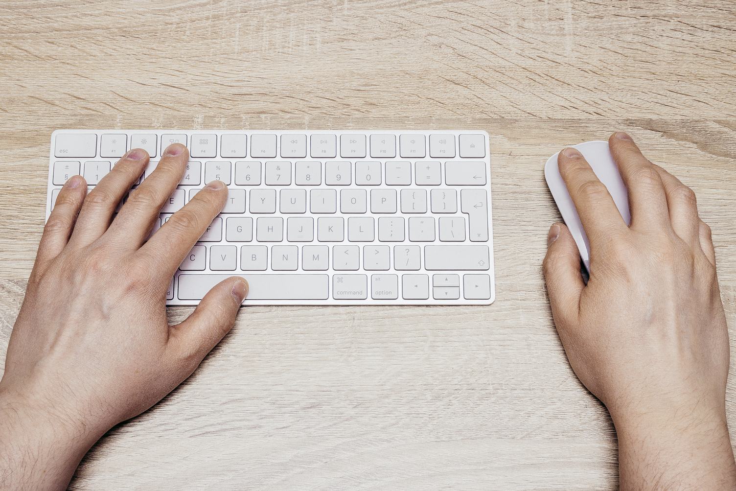 Man Typing on White  Keyboard