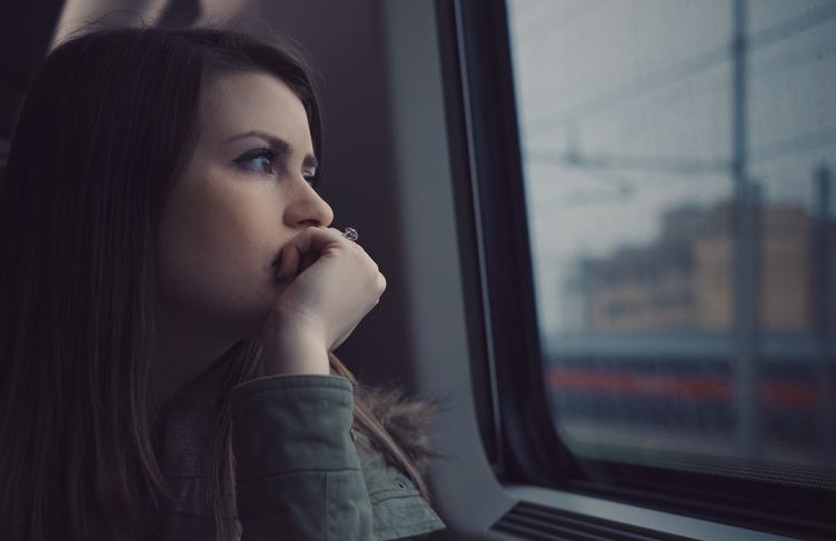 Girl Looking Out the Window Sitting at Train