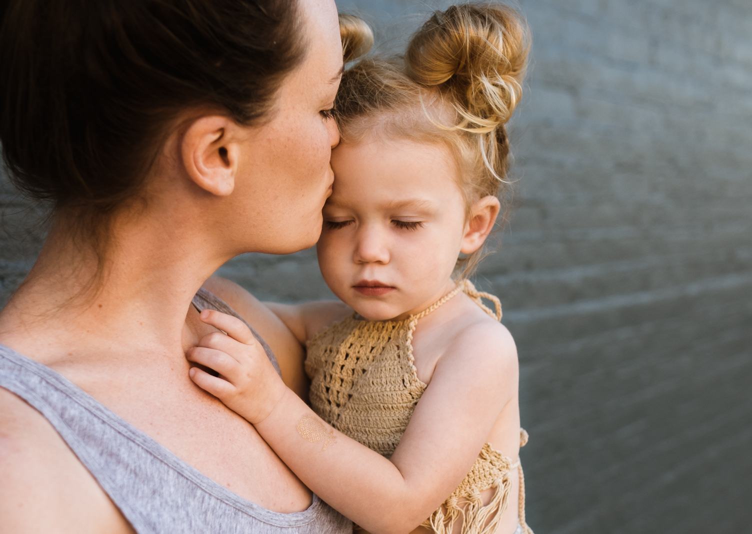 Mom is Kissing her Sweet Little Daughter