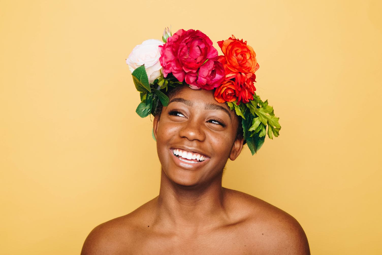Smiling Woman with Flower Werth and Bare Shoulders