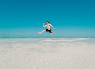 Happy Man Jumping on the Beach