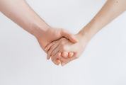 Man and Woman Holding Hands against White Background