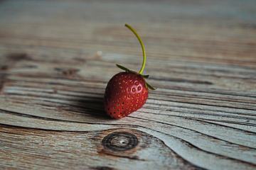 One Ripe Strawberry on Wooden Background